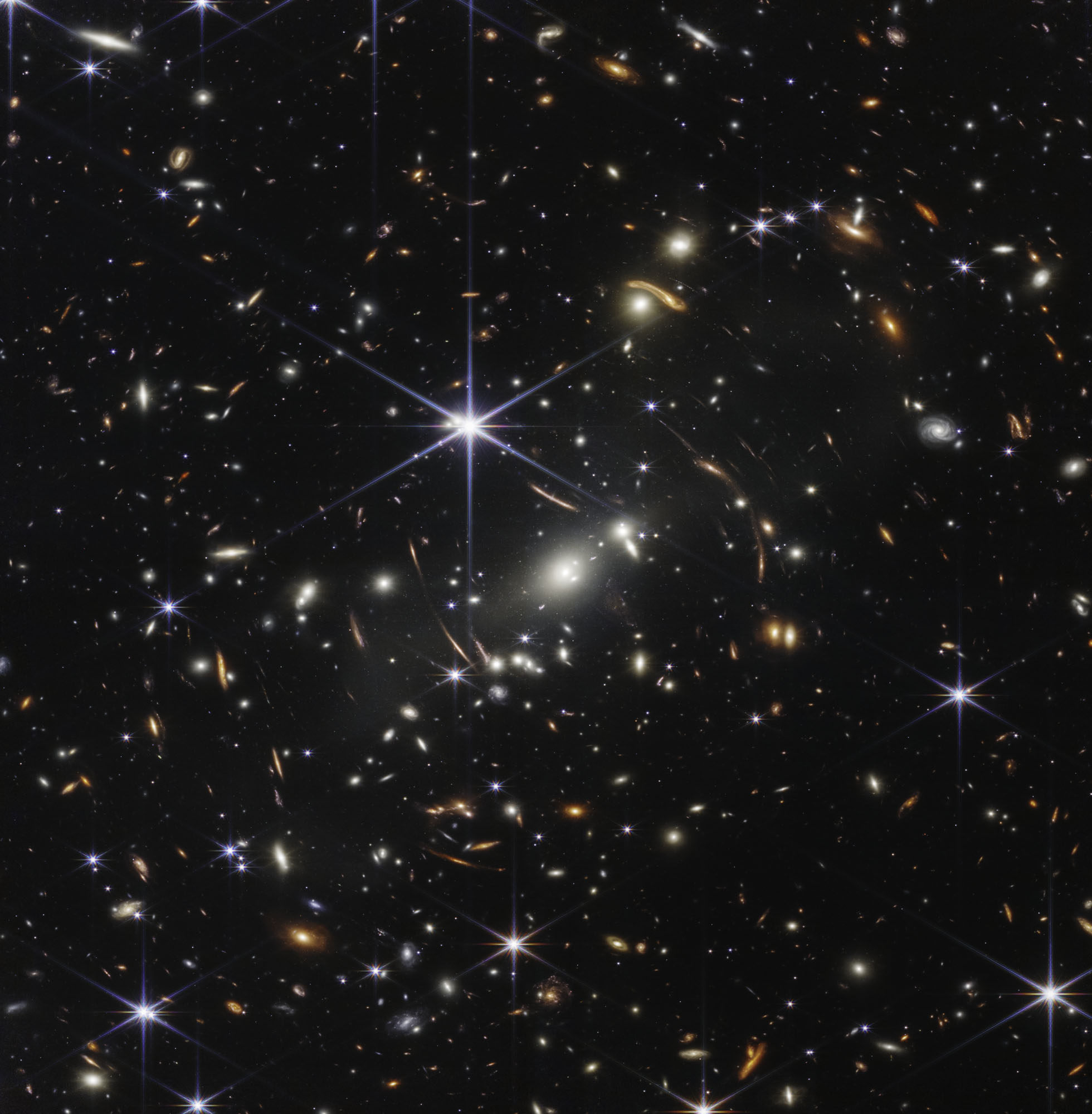 The six pointed stars in this image are foreground stars. Every other object is a galaxy, home to up to 100 billion stars. The yellowy, blue galaxies in the foreground are in a cluster called SMACS 0723, almost six billion light years away. The more red galaxies are behind the cluster, the most distant being seen as they were only 700 million years after the big bang. The galaxy cluster is able to bend light, magnifying and stretching the background, which lets us see even more detail – even if they do look like they’ve been in a funhouse mirror.
