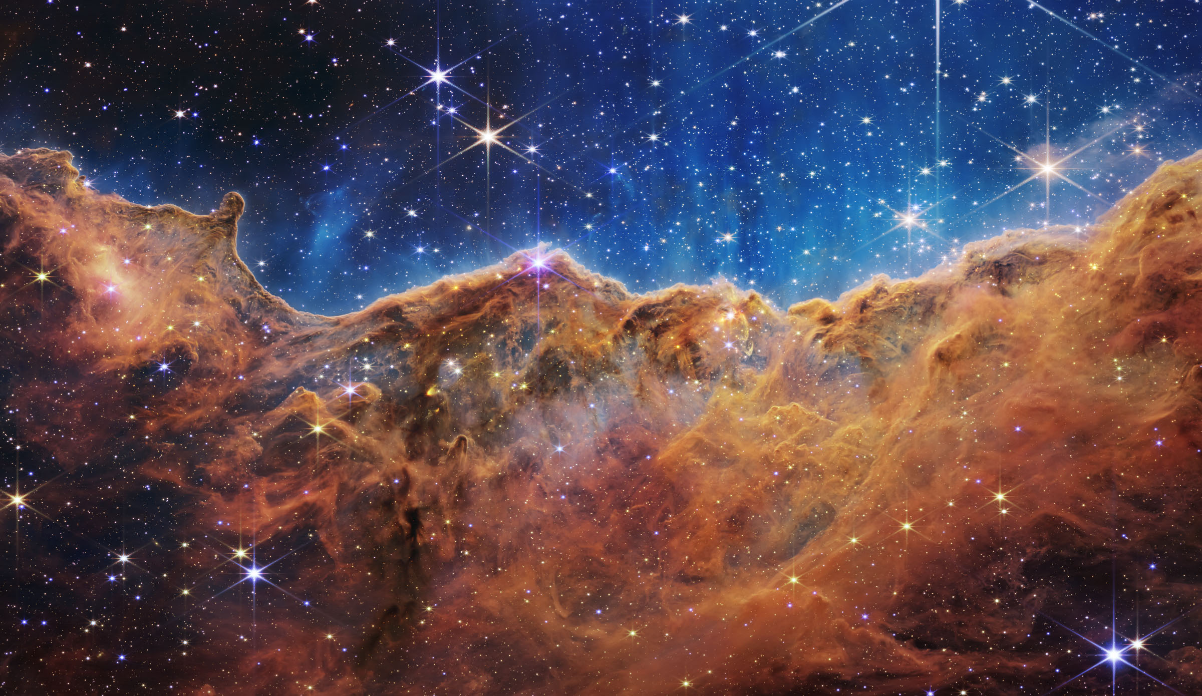 The edge of the Carina Nebula – a cloud of dense Hydrogen gas that is forming stars.